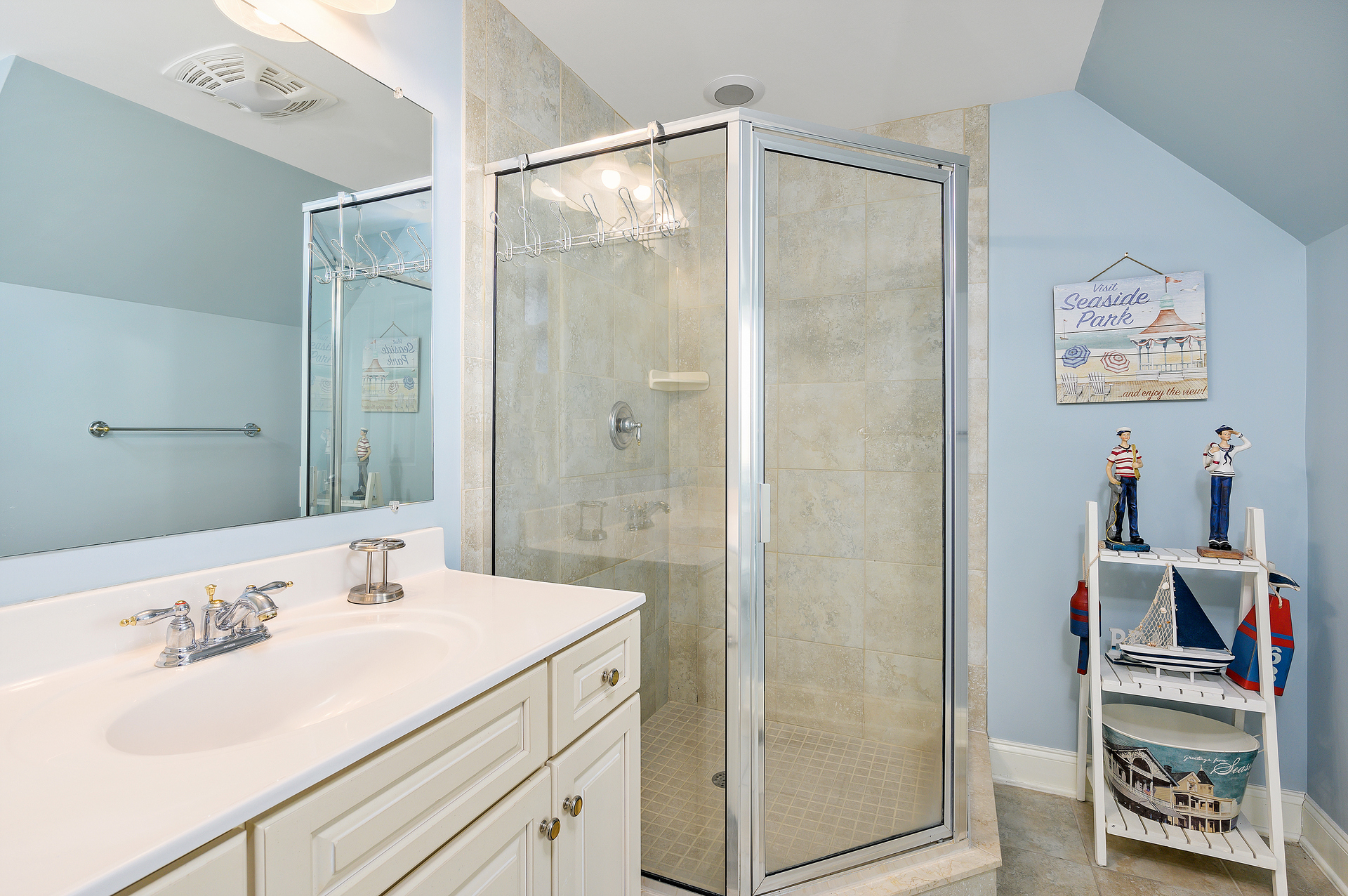 Attached to Bedroom 3 is a Full Bathroom with corner, glassed in shower