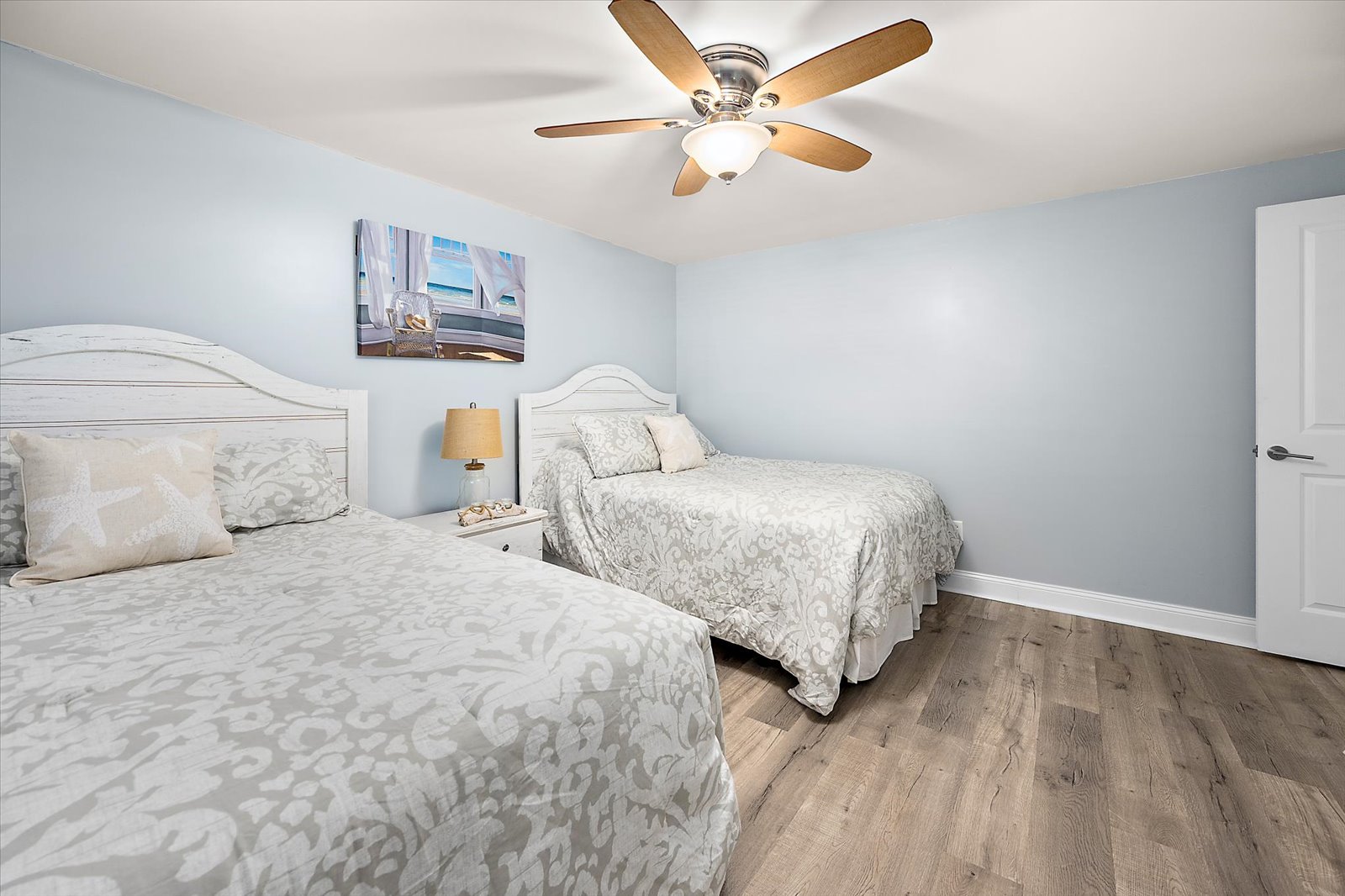 A spacious and relaxing guest room offering plenty of natural light and room to unwind after a fun beach day.