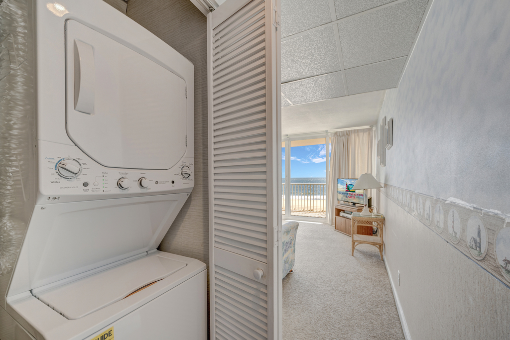A convenient stacked Washer and Dryer in the hallway, ready for your use!