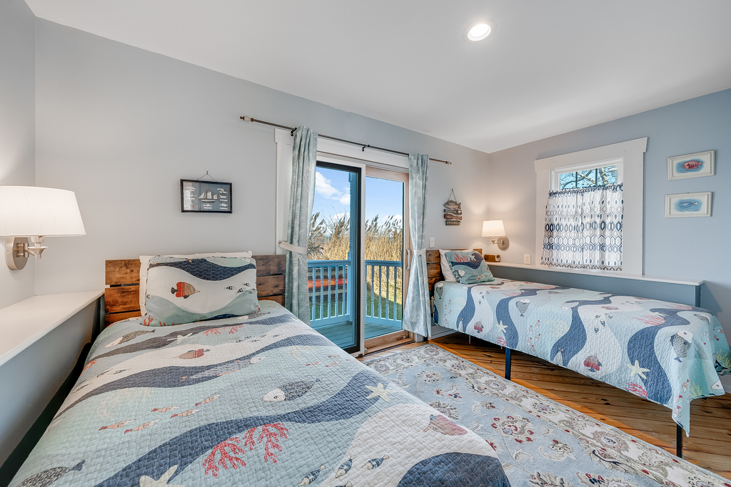Bedroom 1 is on the 1st Floor with a Private Waterfront Balony and fun Under the Sea Theme.