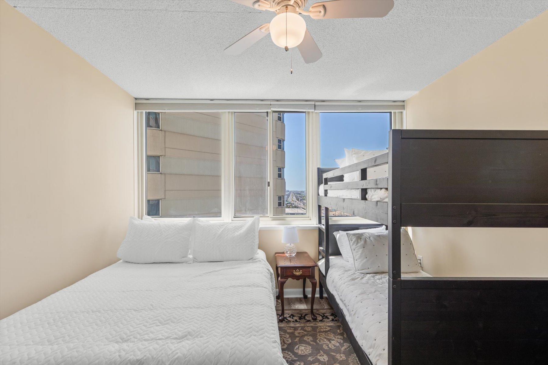 Perfect for kids or larger groups, this spacious bedroom setup offers multiple beds and expansive window views.
