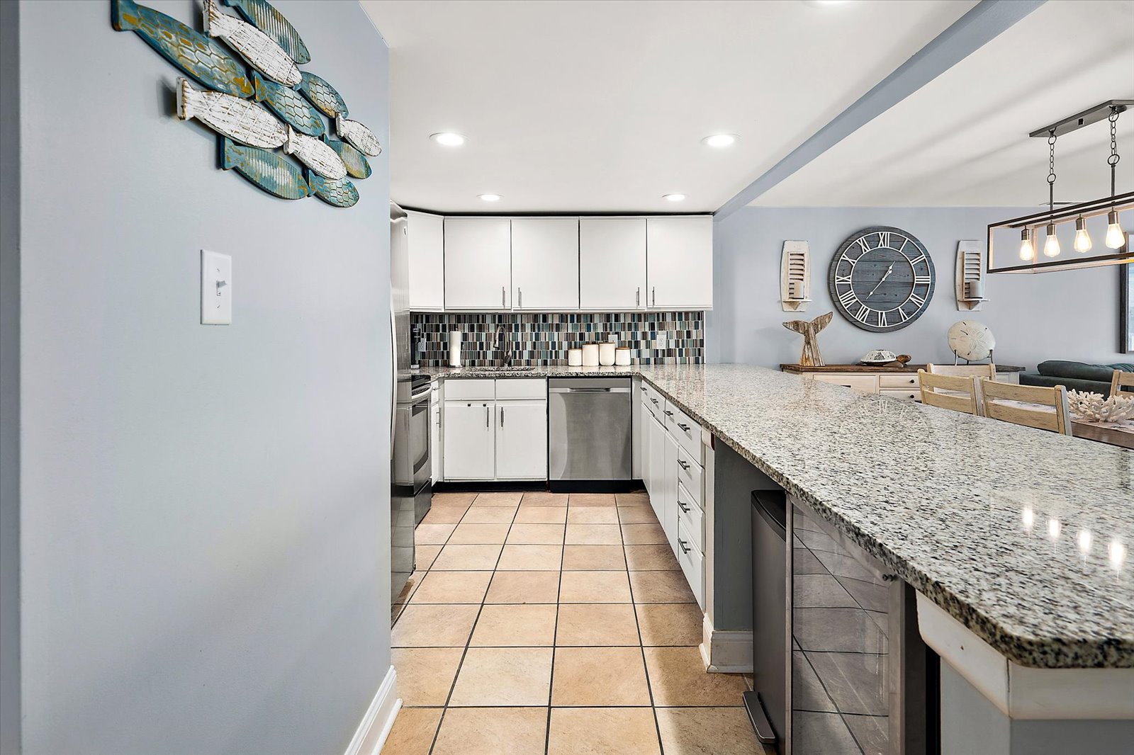 Step into a sleek, modern kitchen space featuring beautiful tile flooring and plenty of room to move around.