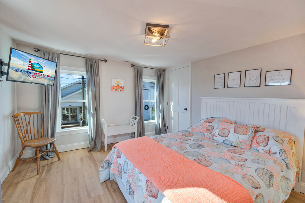 Bedroom 4 is accented with Bright Coral and Queen Bed with Extra Long Twin Trundle.