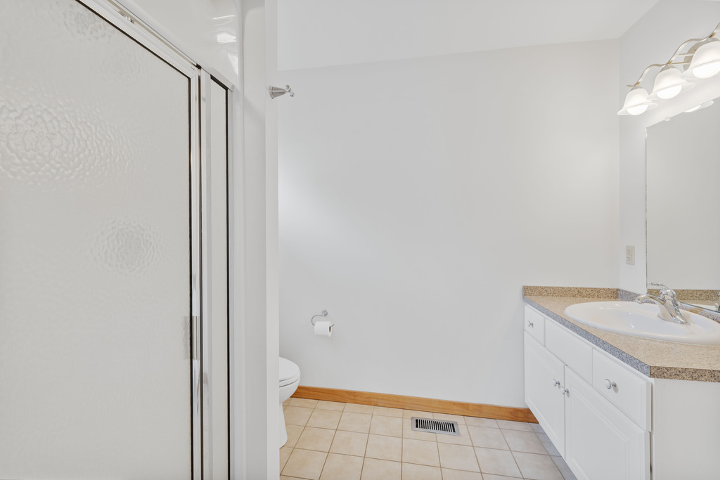The Attached Primary Bathroom has a Walk-in Shower.