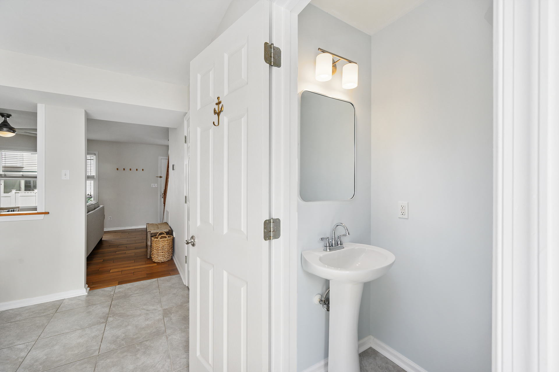 The first floor half bath is just down the hall from the living room