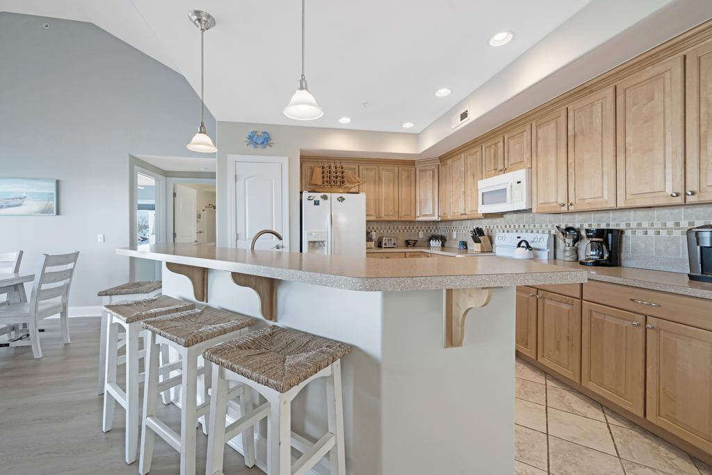 The Living Area opens up to the Chef's Kitchen, with all the comforts of home.