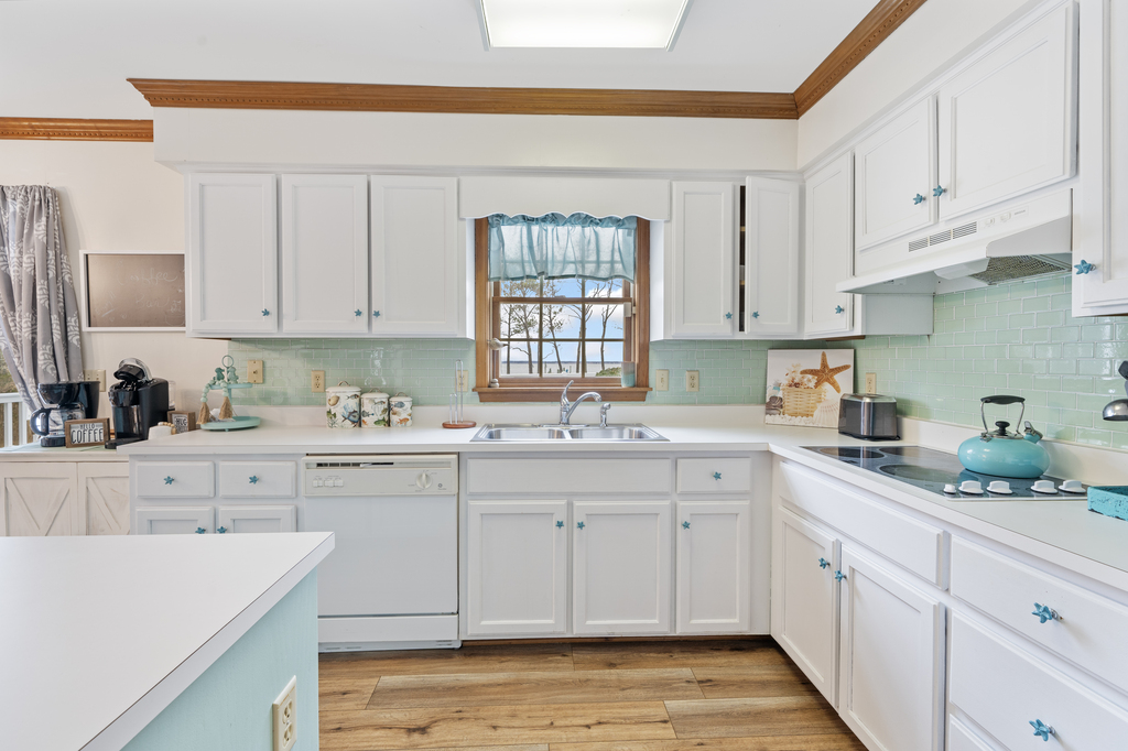 Beachy White Cabinetry and Sea Glass Blue Backsplash.