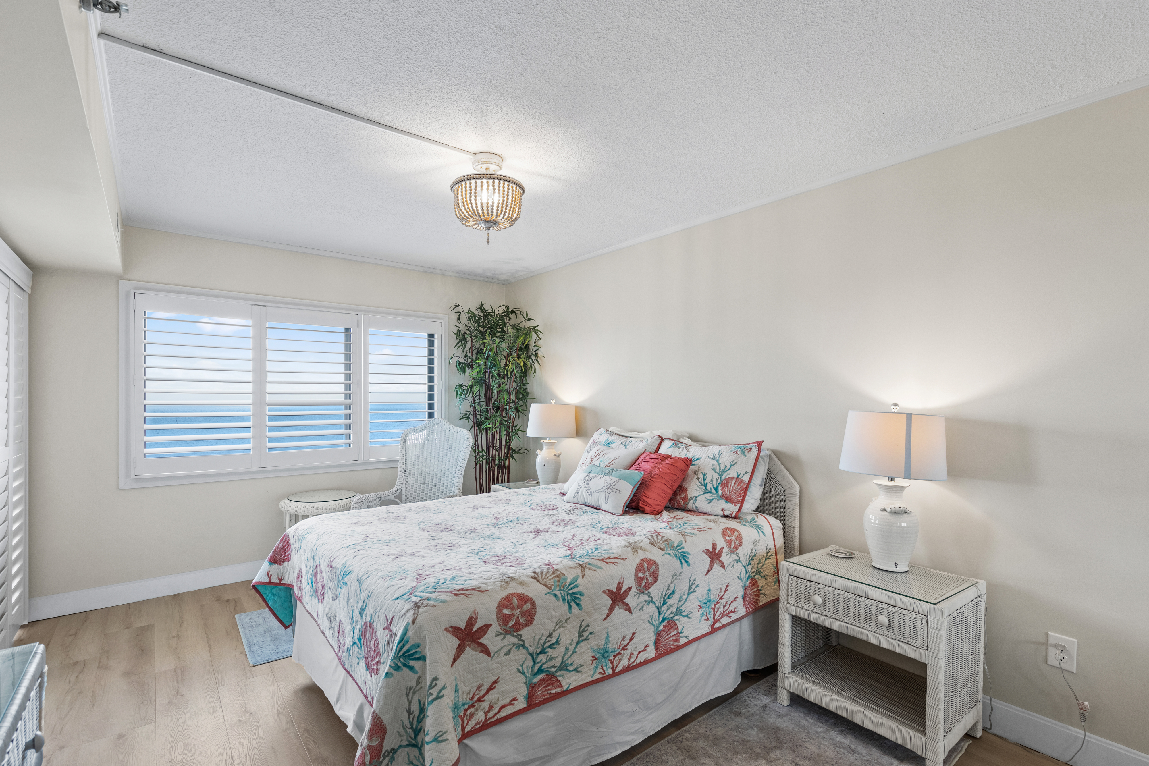 The Primary Bedroom is adorned in cool, calm ocean decor