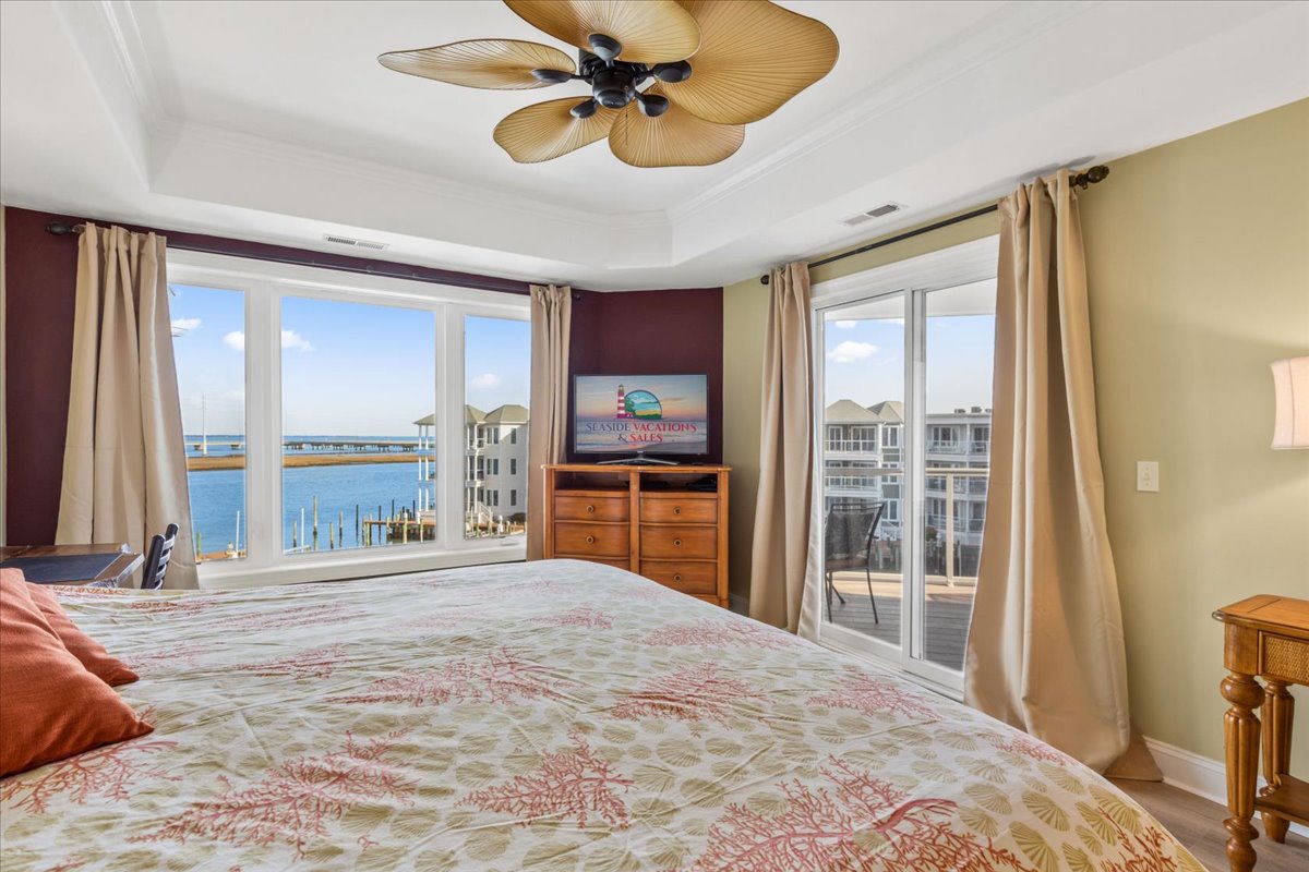 Primary Bedroom has 2 walls of windows and Flat Screen TV.