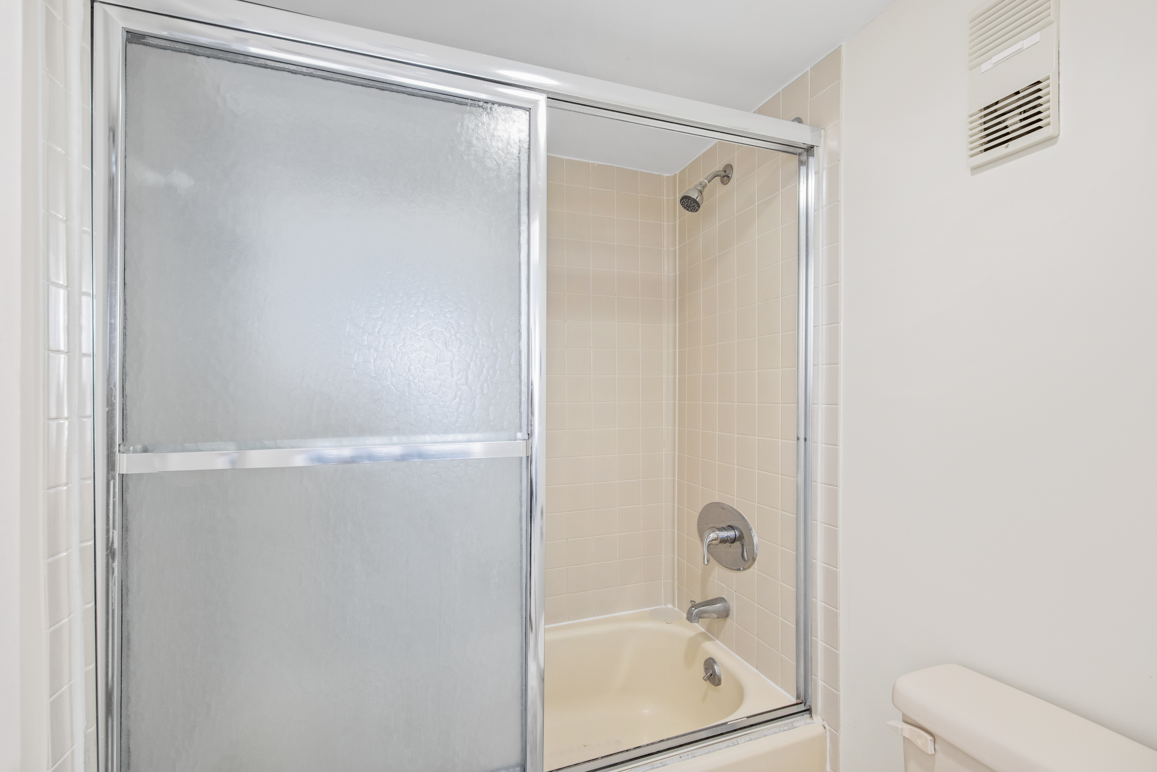 Primary Bath features a tile shower/tub combo.