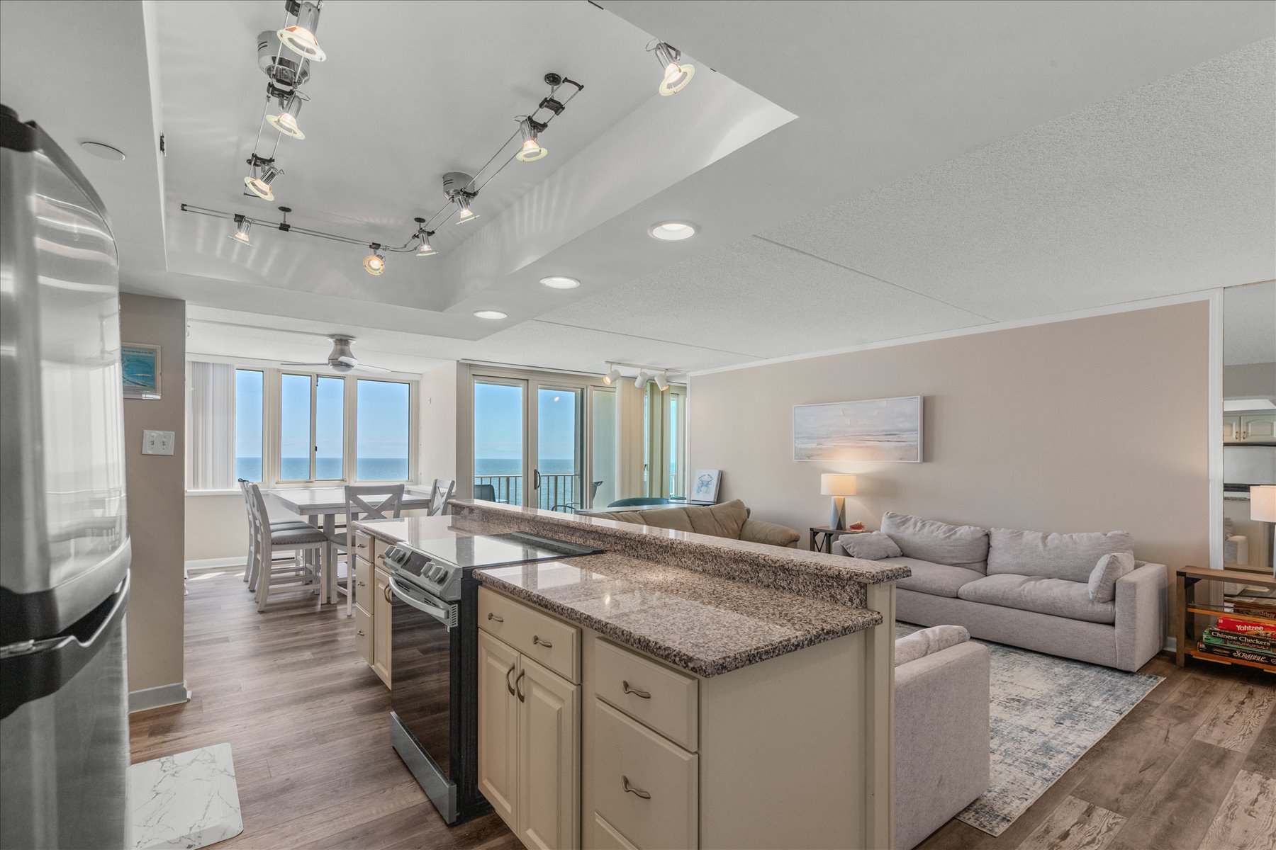 The massive kitchen island features an expansive breakfast bar, offering plenty of seating for snacks or morning coffee.