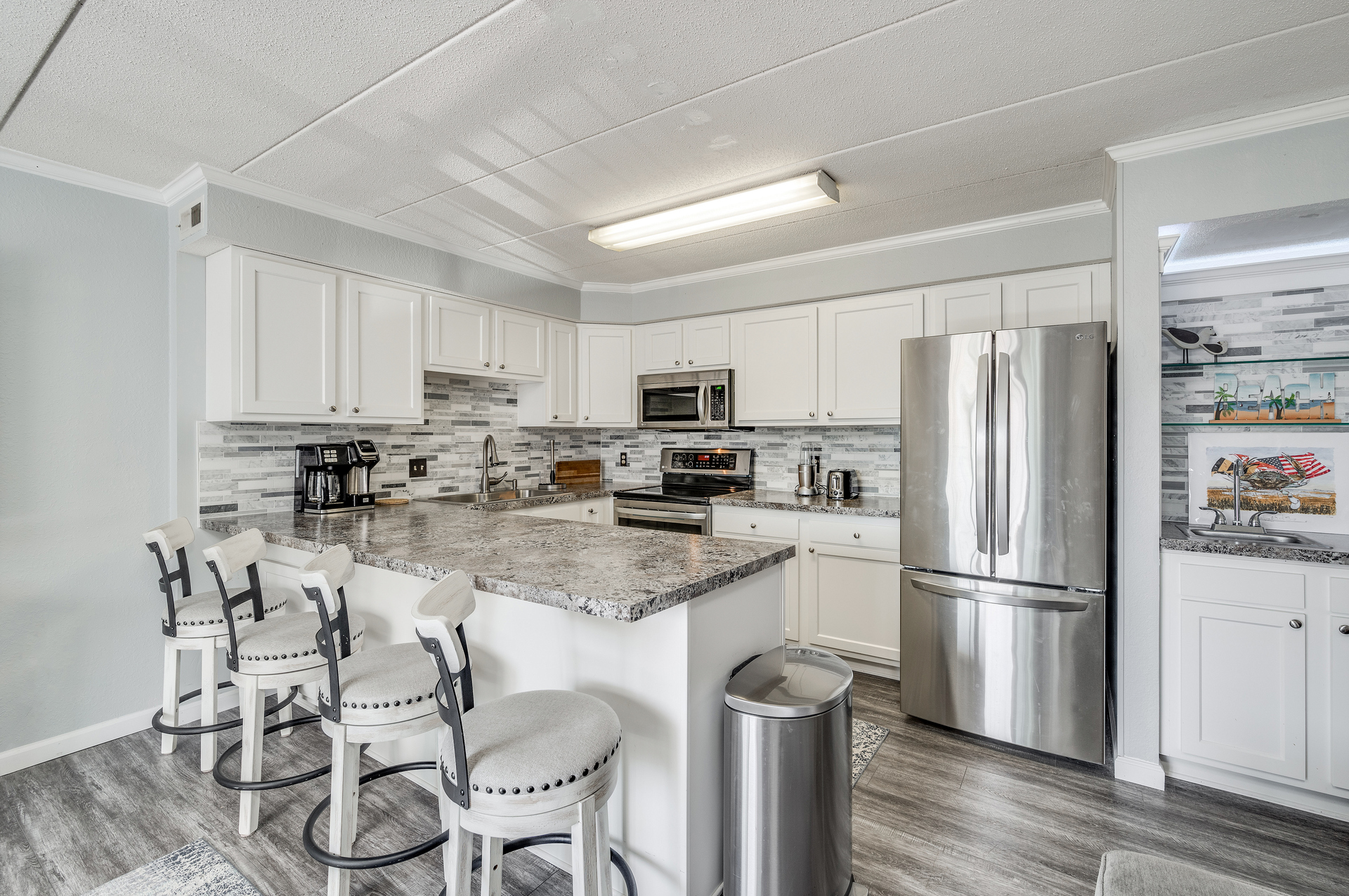 Gorgeous kitchen with breakfast bar and endless cabinet and workspace
