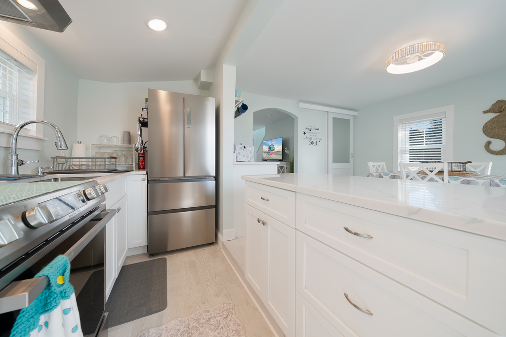 Gorgeous Gourmet Kitchen with Stainless Appliances, gleaming Granite, and beachy white cabinetry.