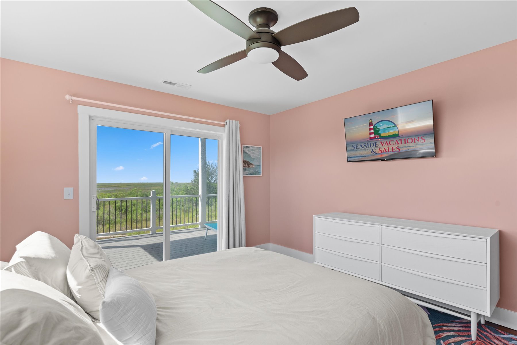 Bedroom 2 is dressed in pink and has a comfy Queen Bed.