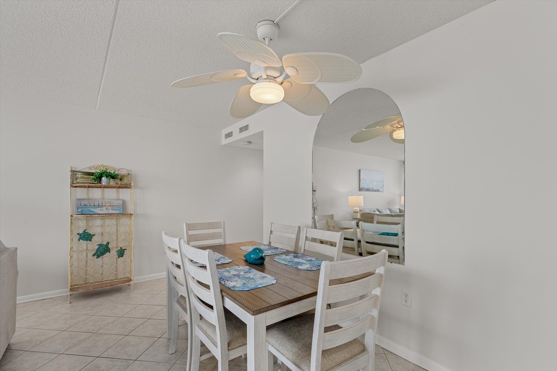 The dining table, seating 6, offers plenty of space for the whole family to enjoy a warm, home-cooked meal.