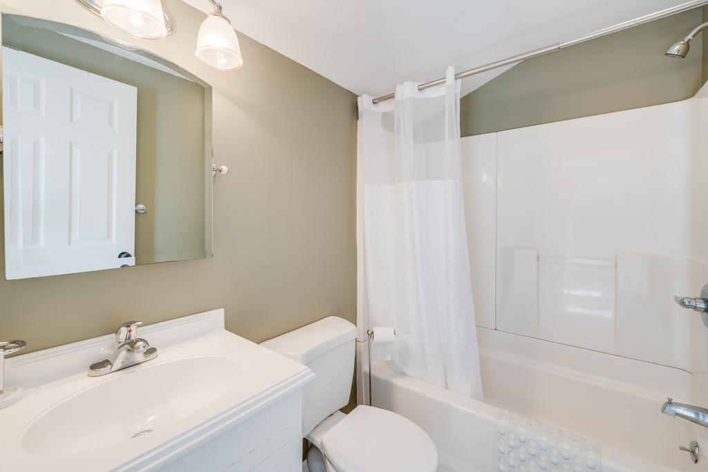 Full Bath 1 is just off the Kitchen with a Tub/Shower Combo, and is across the hall from Bedroom 1.