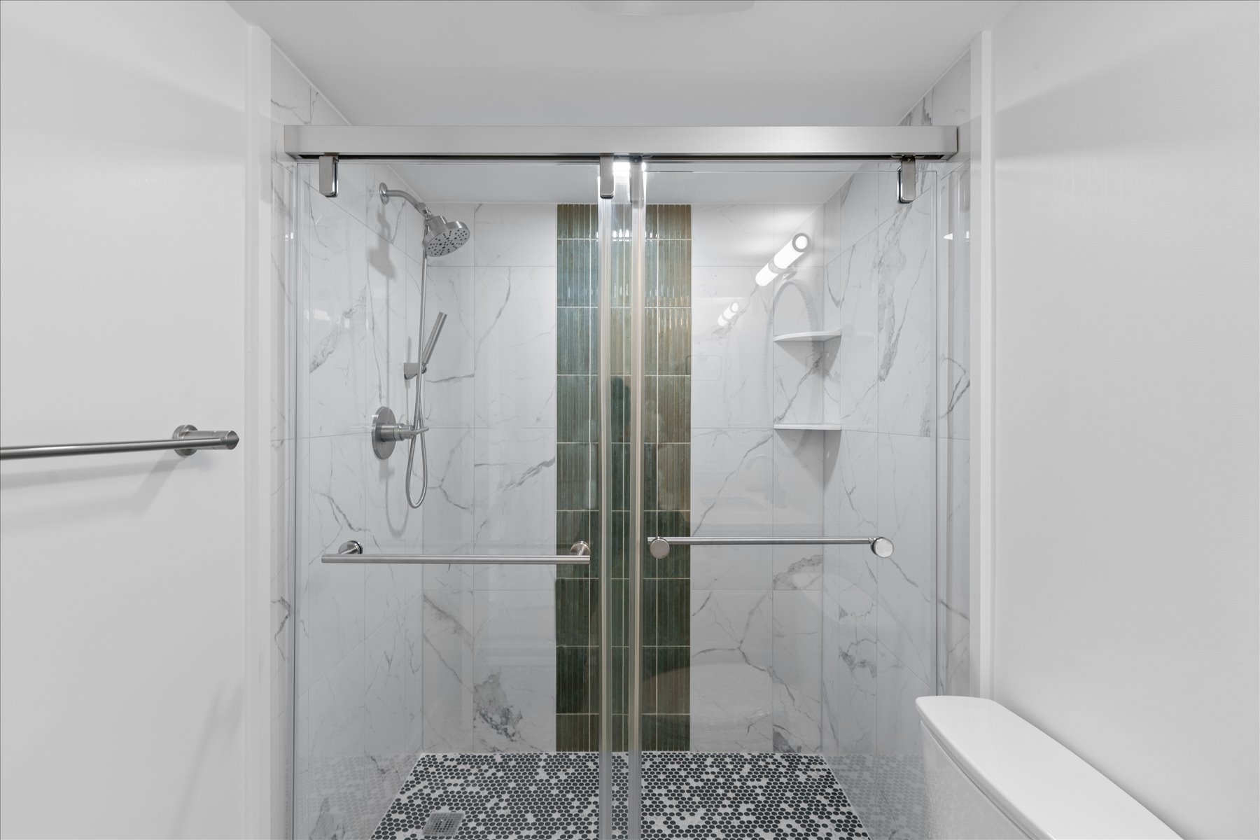 Spacious walk-in shower with custom tile.
