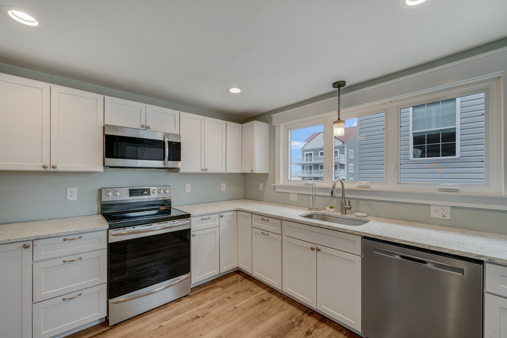 Well-Stocked Kitchen with Stainless Appliances and stunning Quartz Countertops.