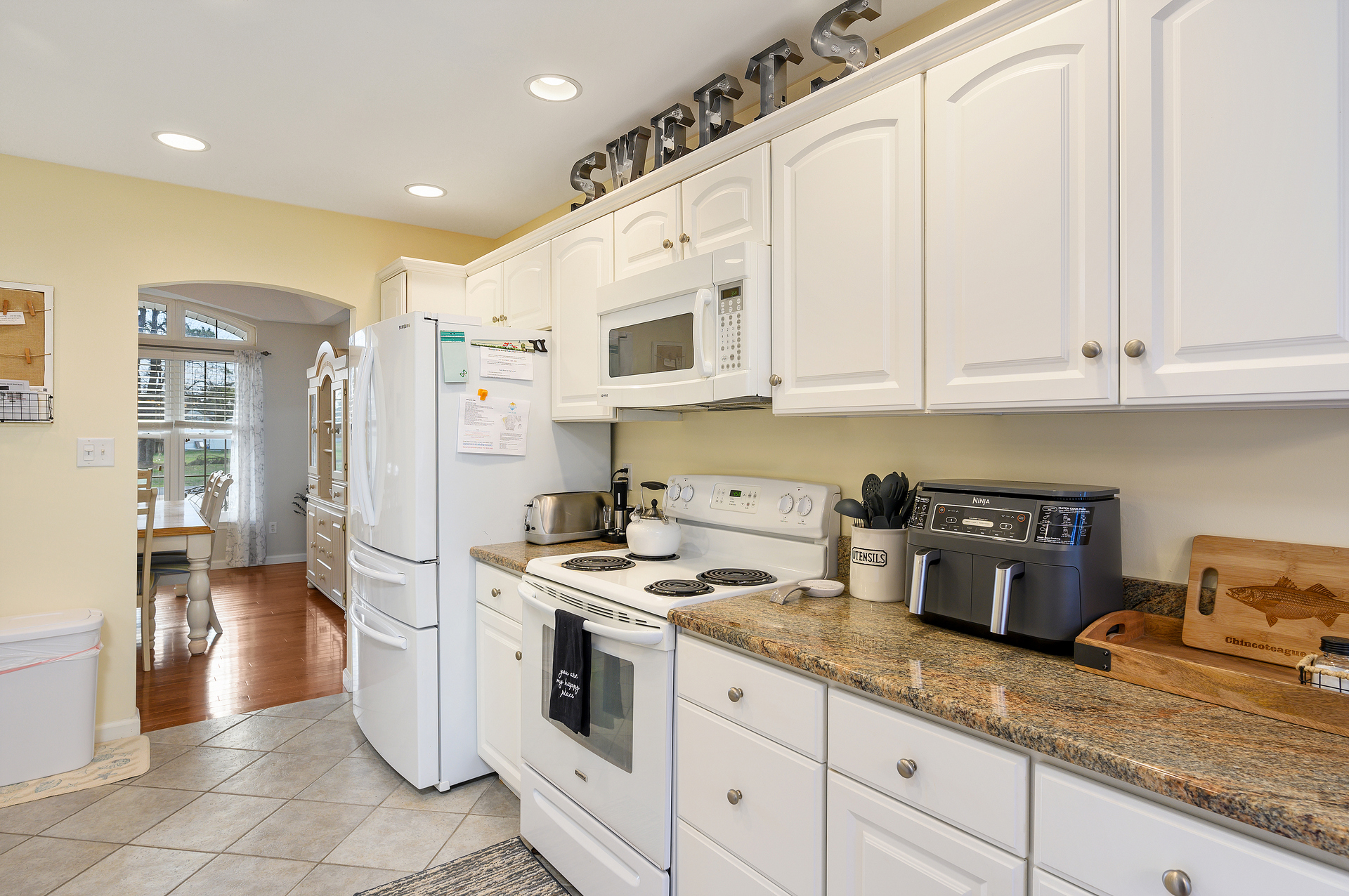 Beachy White Cabinetry and Solid Surface Countertops.