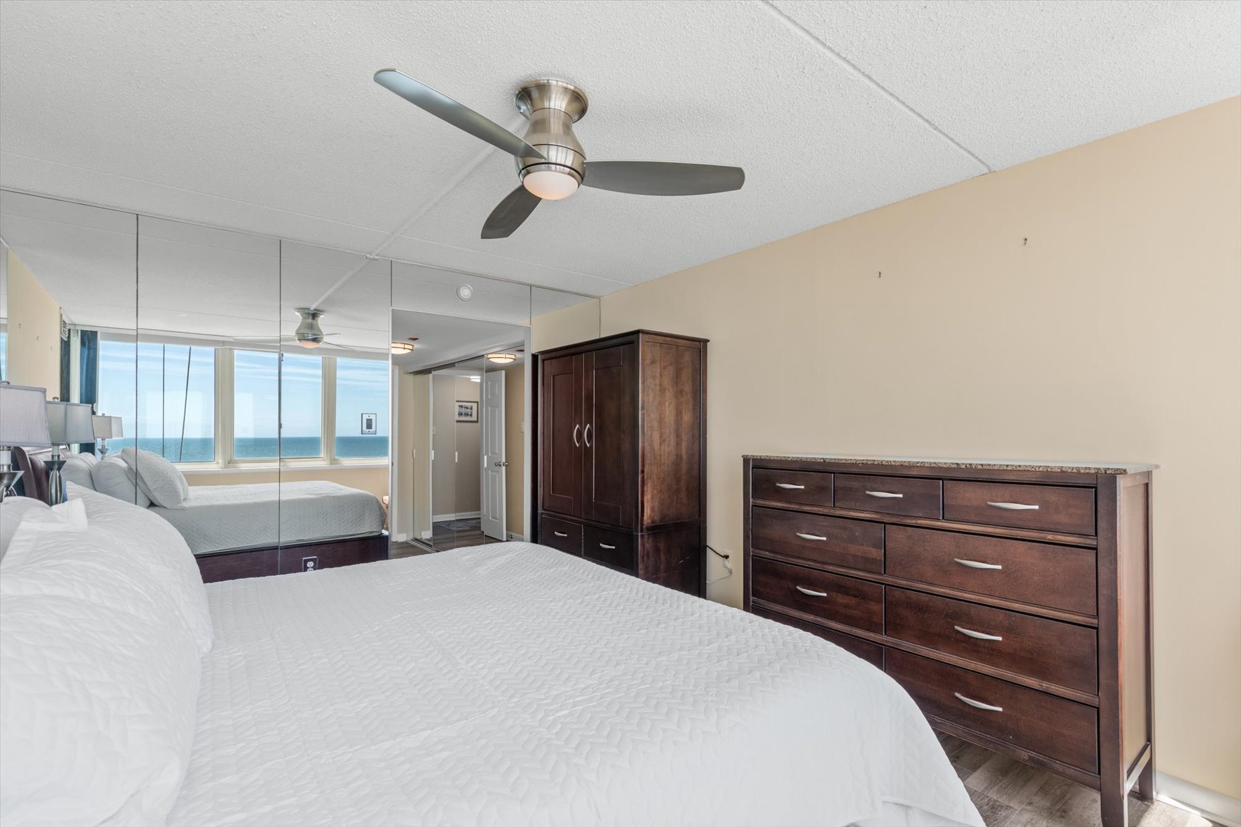 Thoughtfully furnished with rich wood dressers and a wardrobe closet, providing plenty of storage space for your stay.