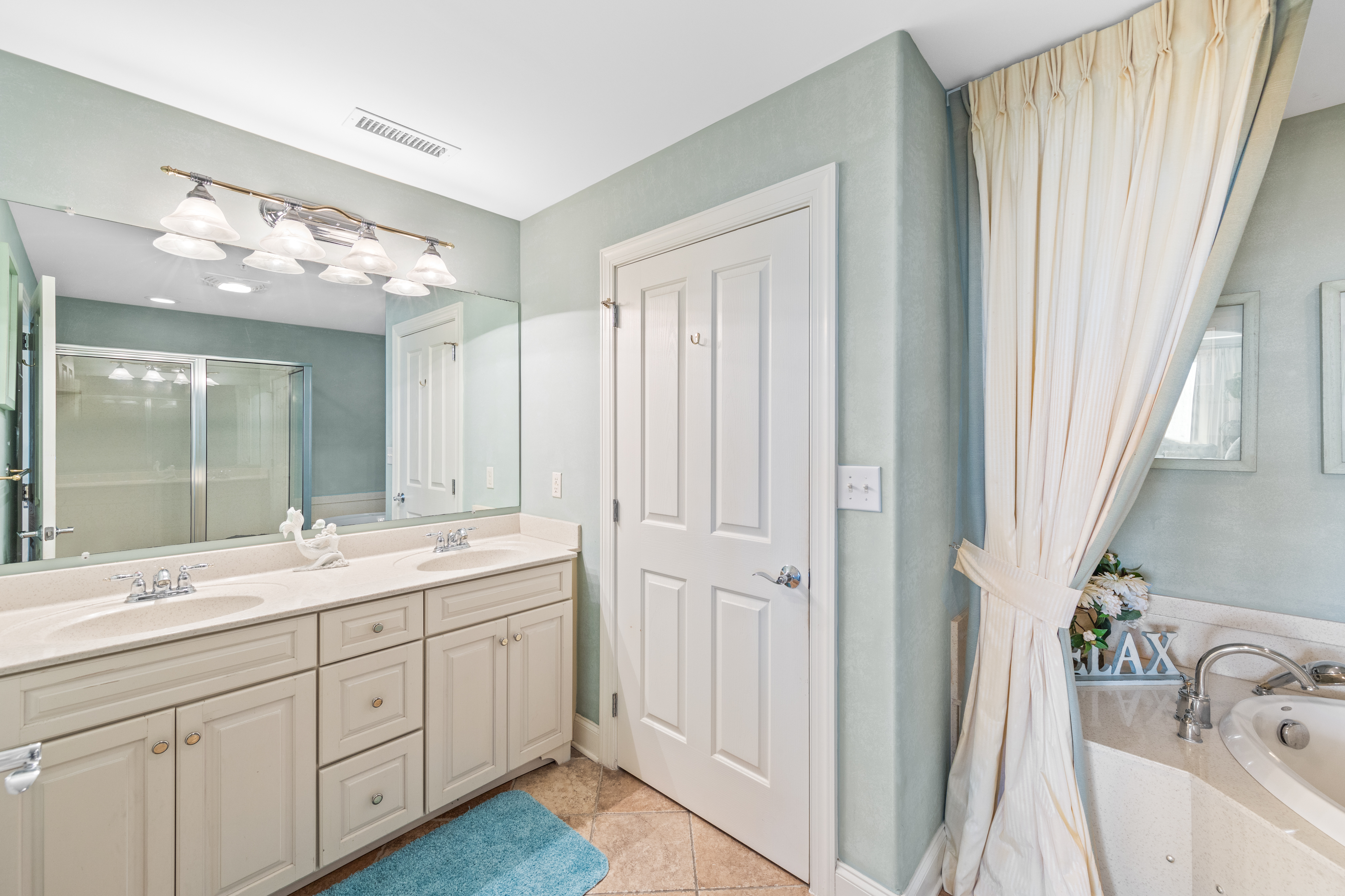 Primary bath features a nice big vanity and a private water closet.