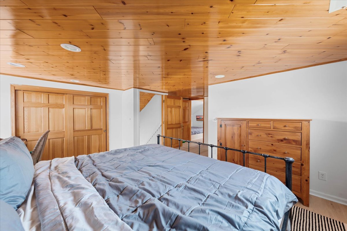 Bedroom 3 has a King Bed and Warm Wood Accents.