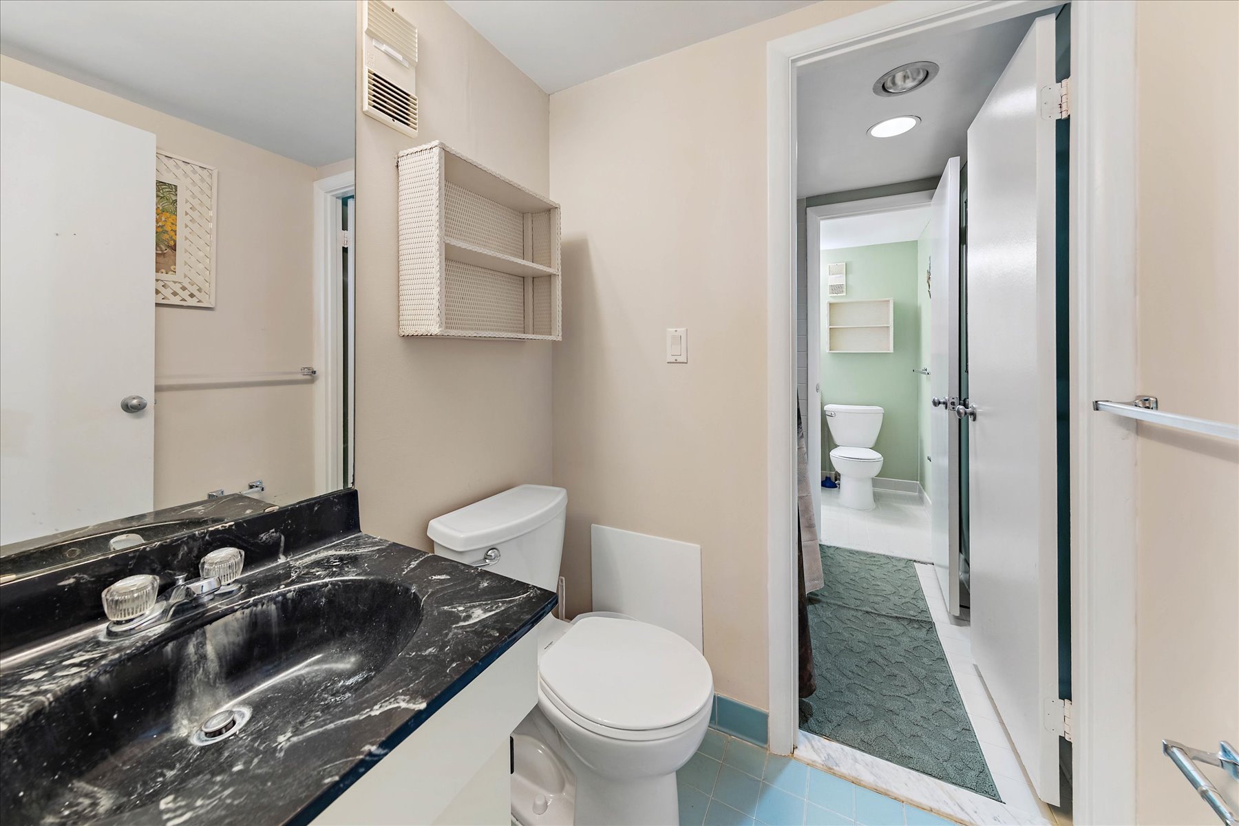 Shared Shower/Tub Combo area connects both Toilet/Vanity areas.