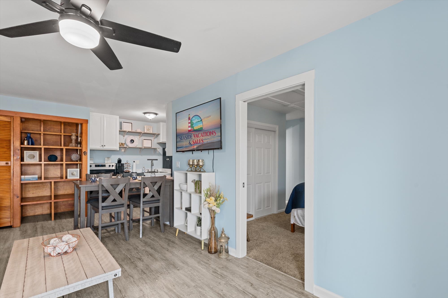 A view from the bedroom hallway highlights the seamless flow back into the main living and kitchen spaces.