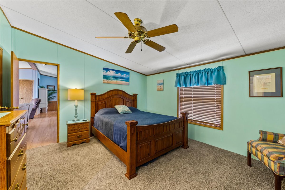 Bedroom 1 is a Master with a comfy Queen Bed and Colors of Sand and Sea.