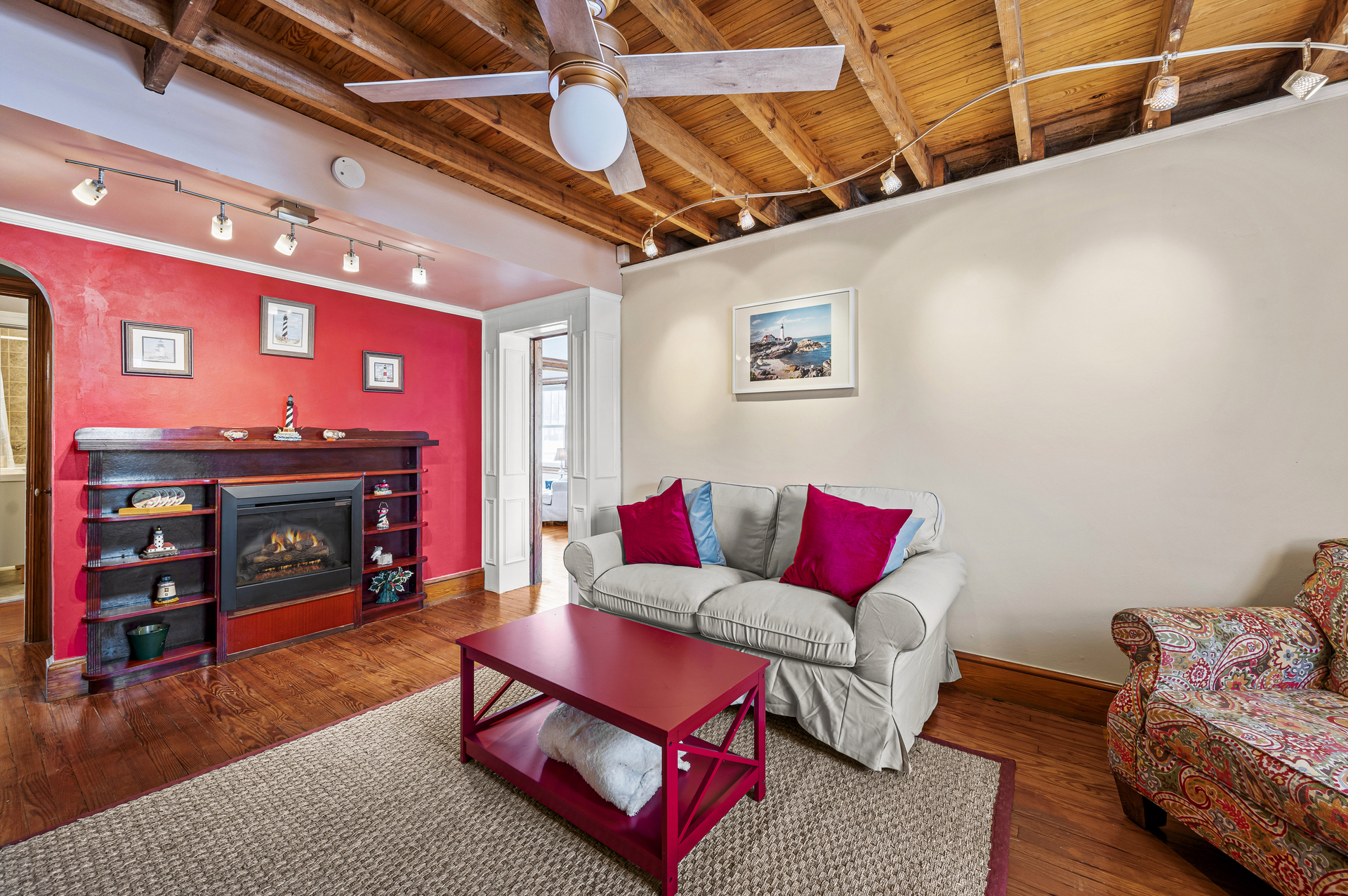 Relax in the Living Area with Electric Fireplace, Free WiFi, and Flat Screen TV.