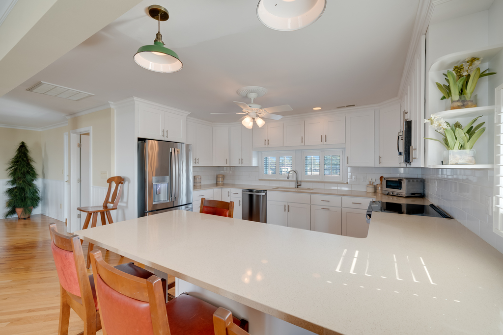 Stainless Appliances and gleaming Quartz Countertops.