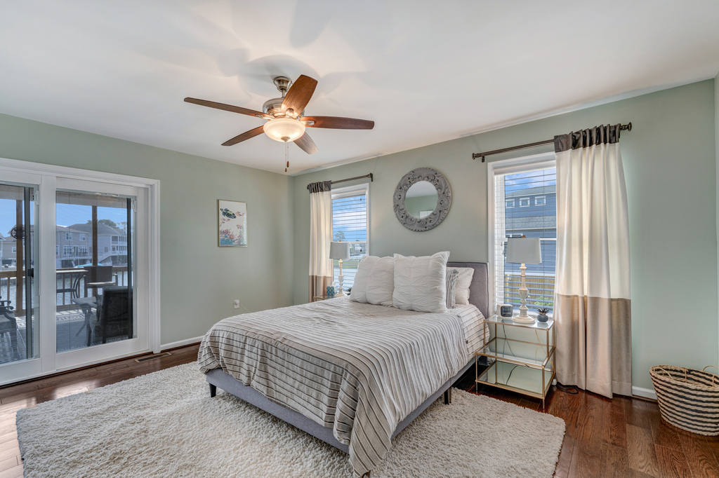 Bedroom 1 is a Primary Bedroom with a Queen Bed and Private Access to the Screened Porch.