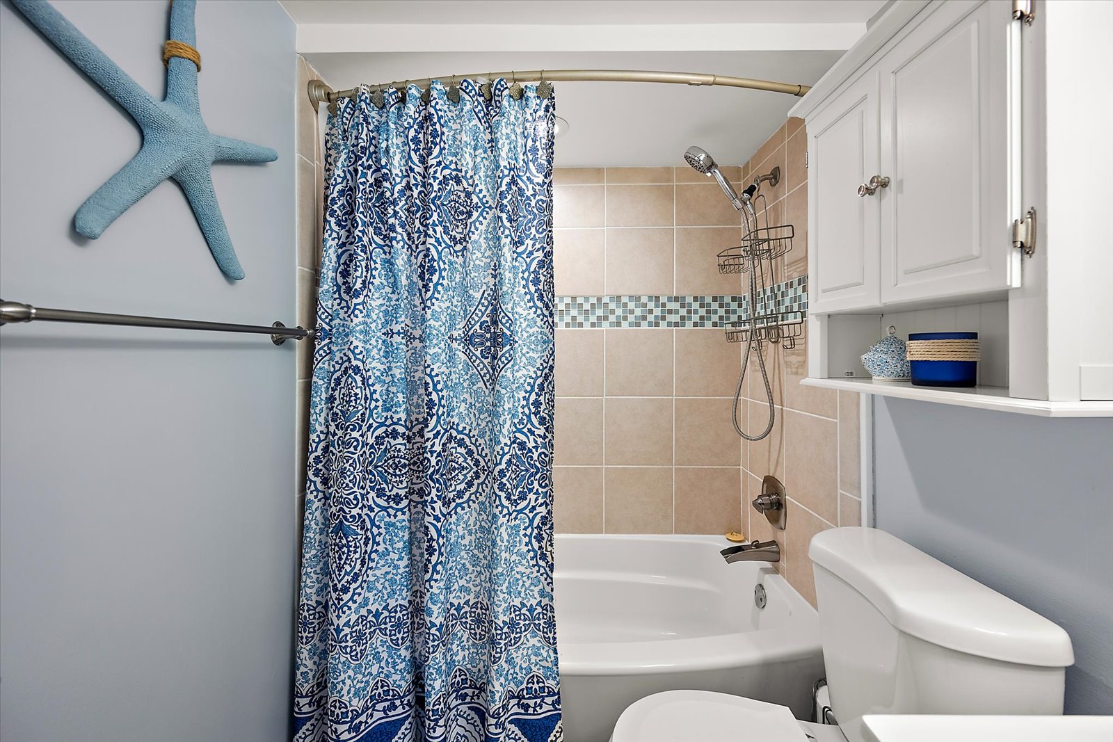 Freshen up after a fun-filled day at the beach in this clean bathroom complete with a full tub and shower combination.