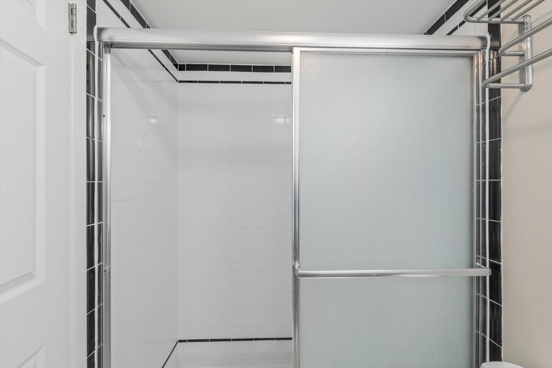 Enjoy a refreshing rinse in the pristine walk-in shower, complete with sleek glass sliding doors.