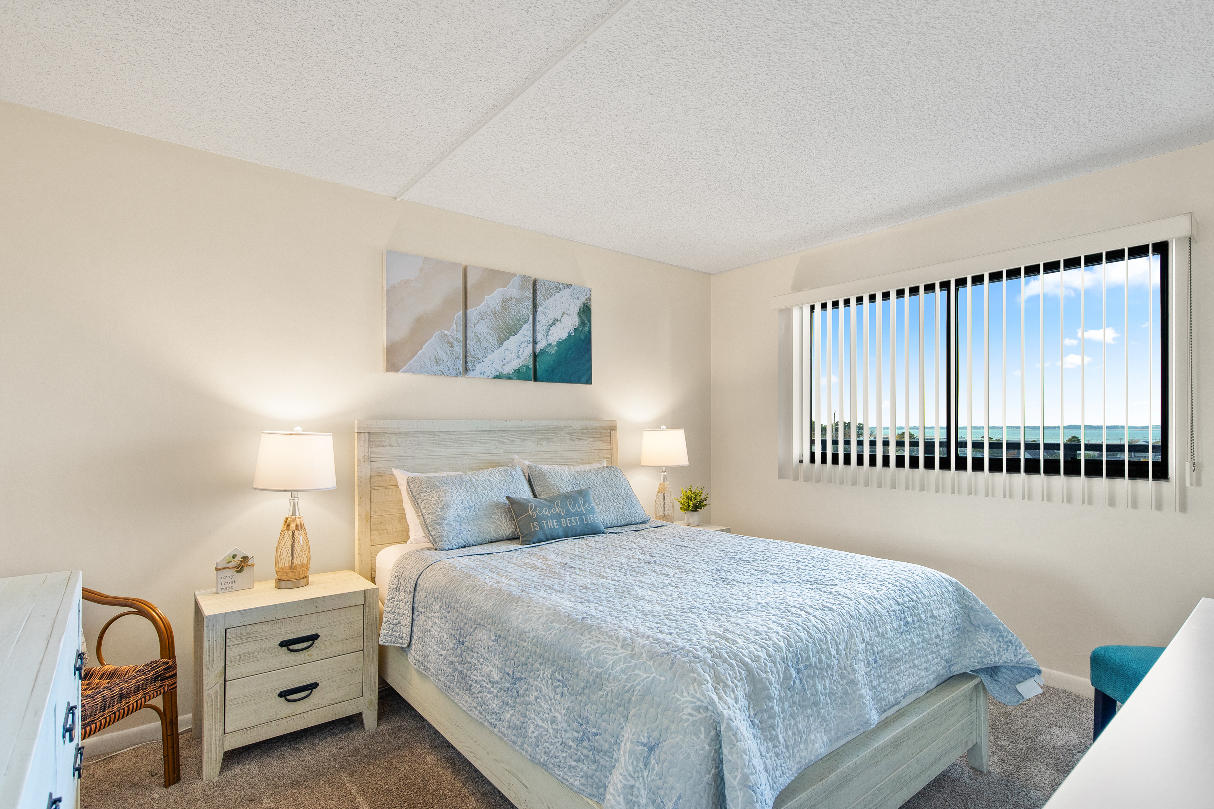 The Primary Bedroom is adorned in colors of Sand & Sea.