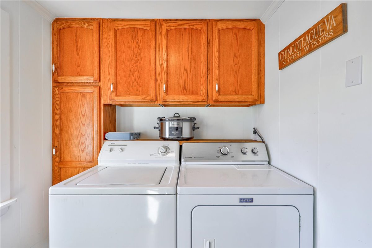 The Mud Room off the Kitchen houses a Full Size Washer and Dryer, and leads to the back deck.