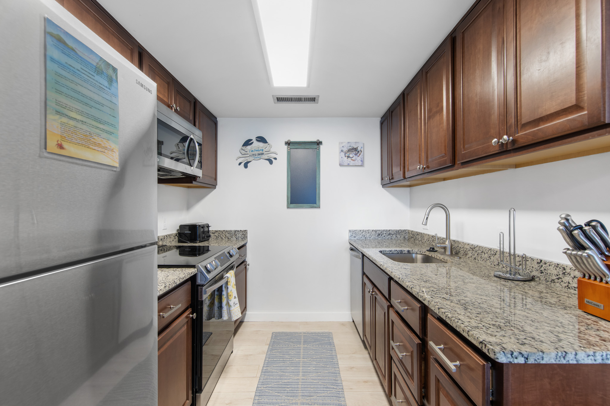 This kitchen offers gleaming granite countertops and warm wood cabinets.