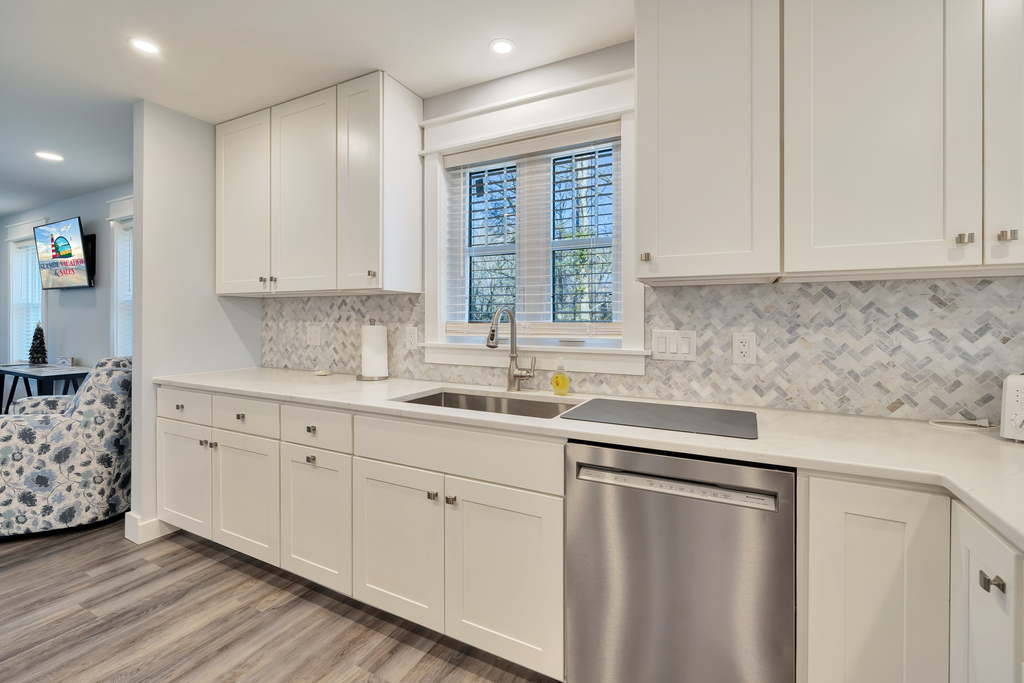 Stainless Appliances, Tile Backsplash, and beachy white cabinetry.