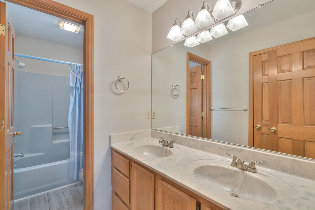 Attached Full Bath with Double Vanity and Tub/Shower Combo.
