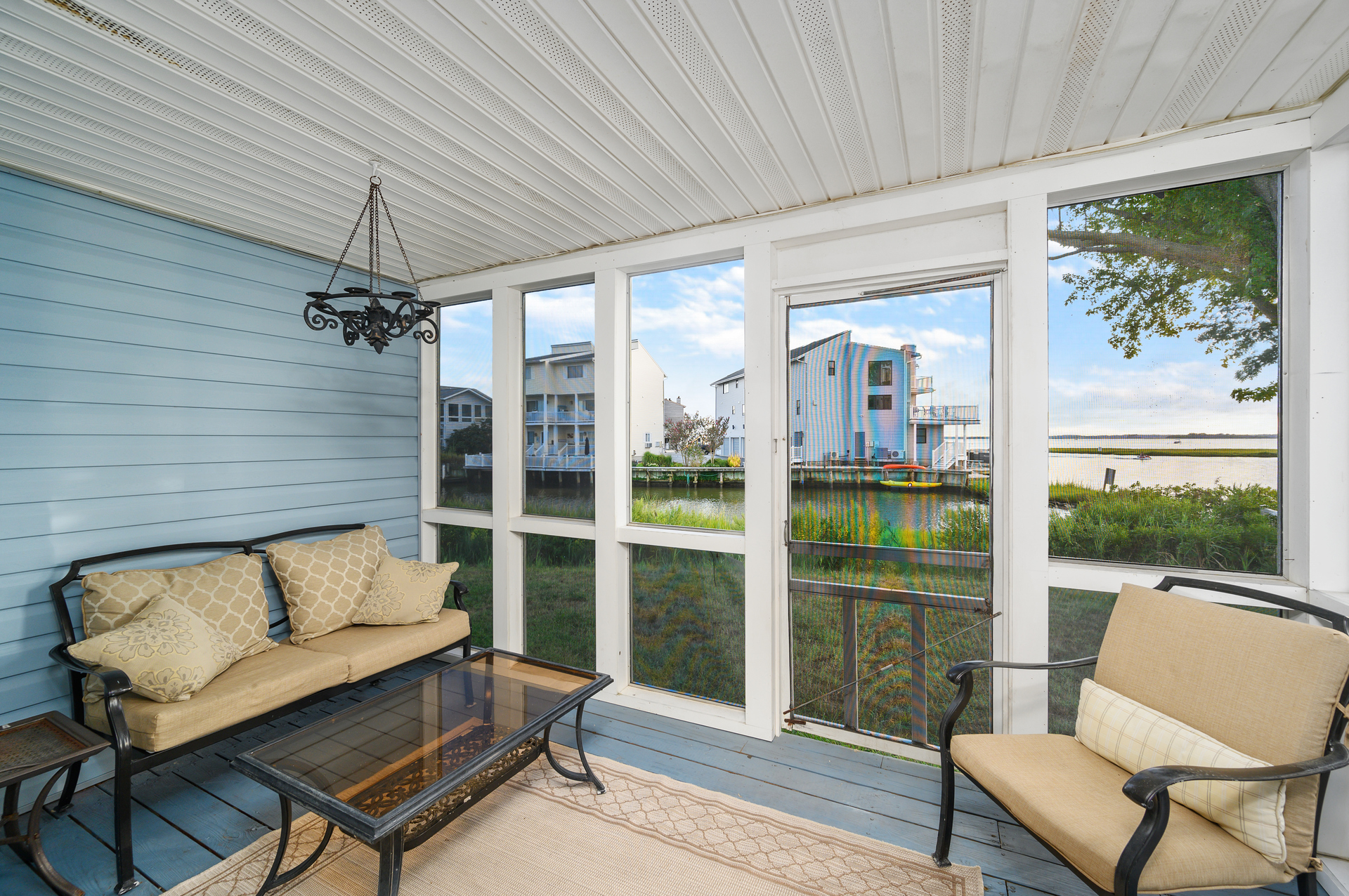 This cozy, screened in porch is located just off the living room.