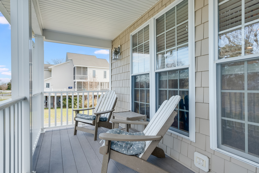 The covered porch offers the perfect retreat with comfortable seating where you can unwind with morning coffee or evening conversations.