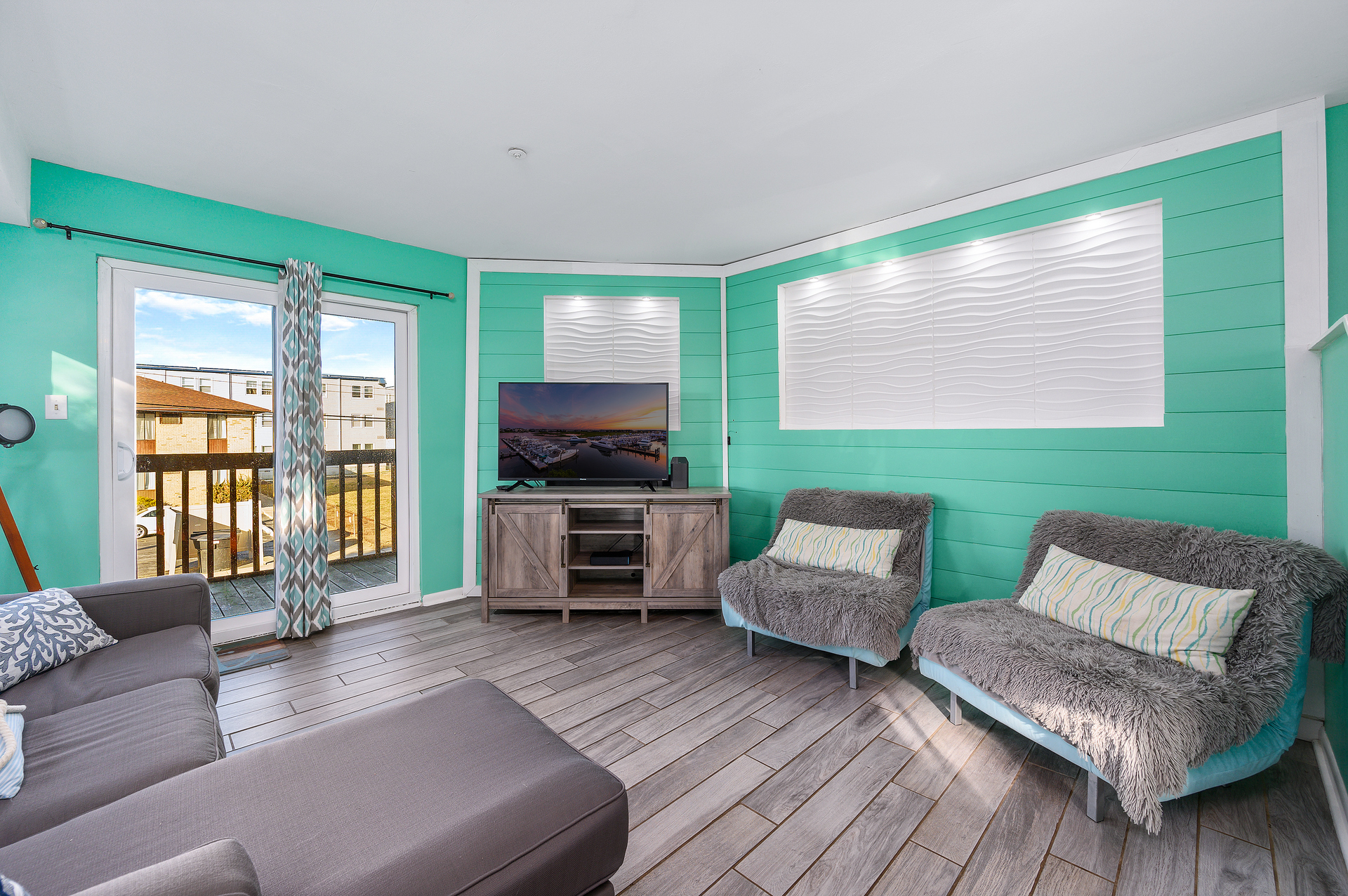 The main living area features a balcony, perfect for taking in the sweet, salty air