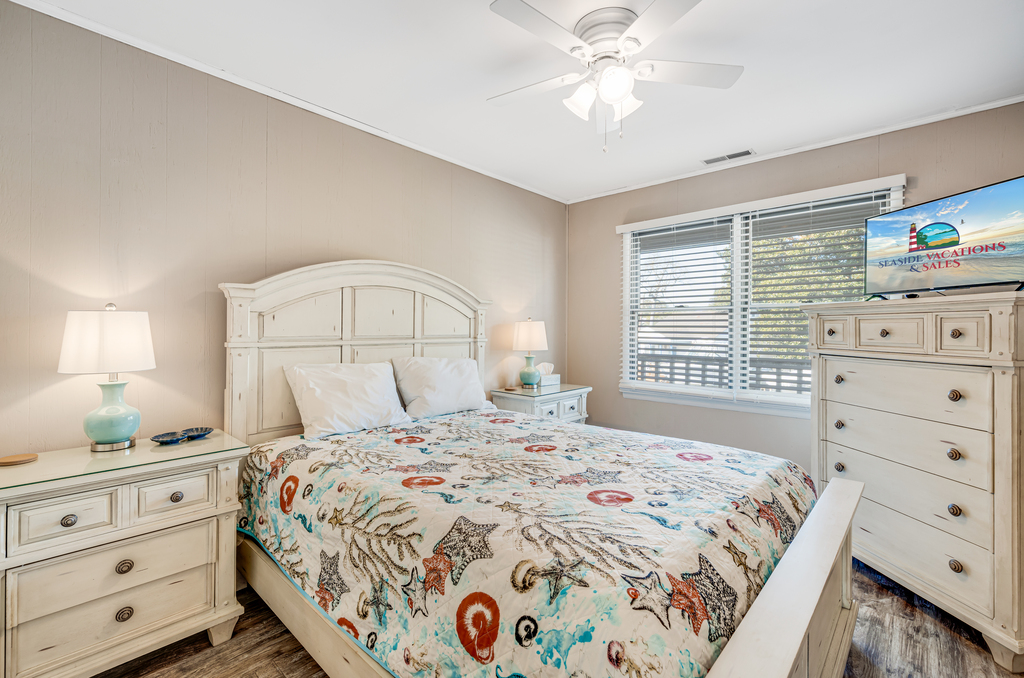 Bedroom 1 has a comfy Queen Bed and serene coastal decor.