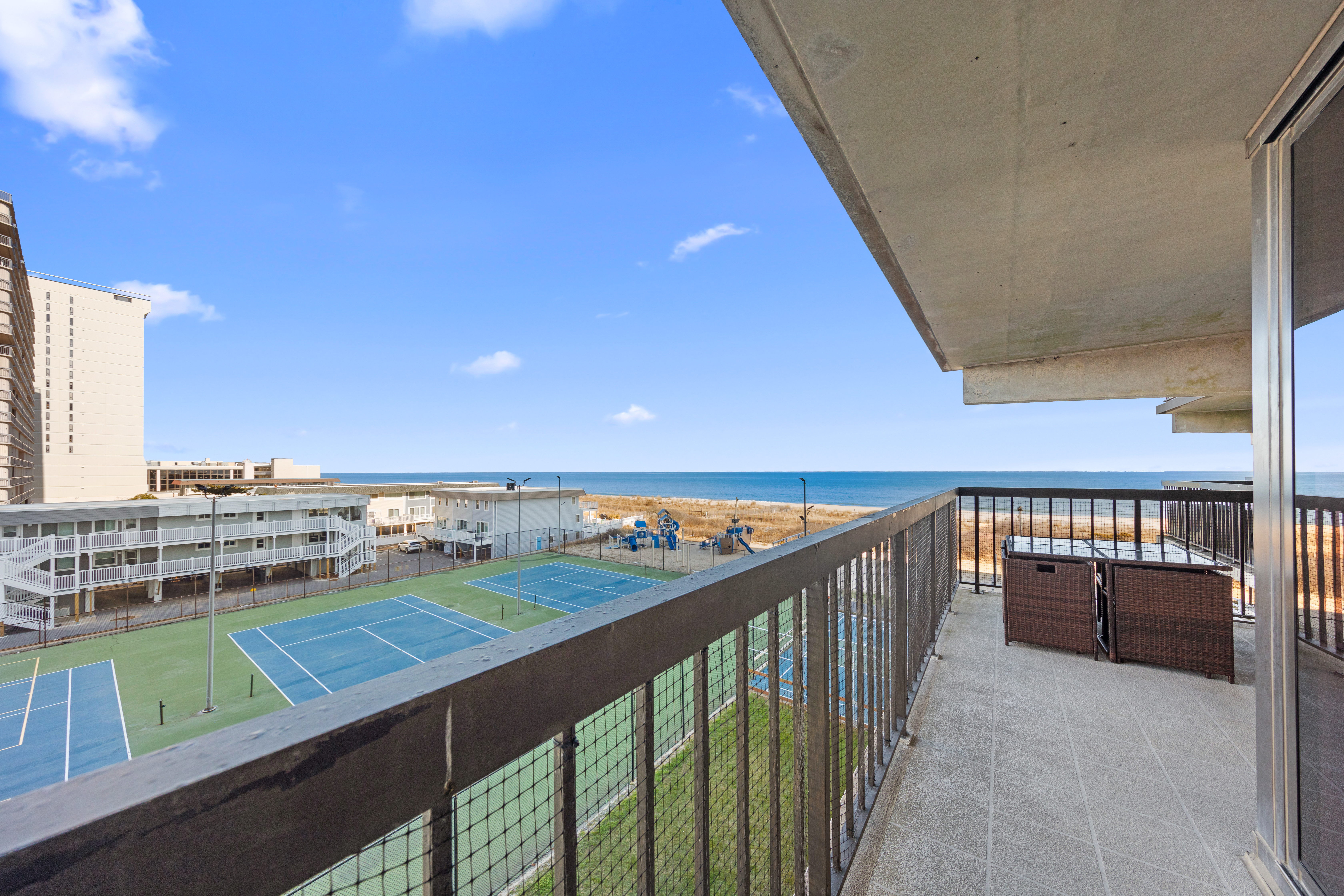 Spacious Balcony overlooking the Beach & Court Areas.