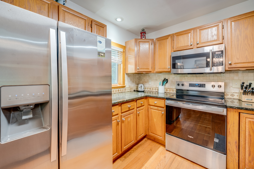 Stainless Appliances and warm wood cabinetry.