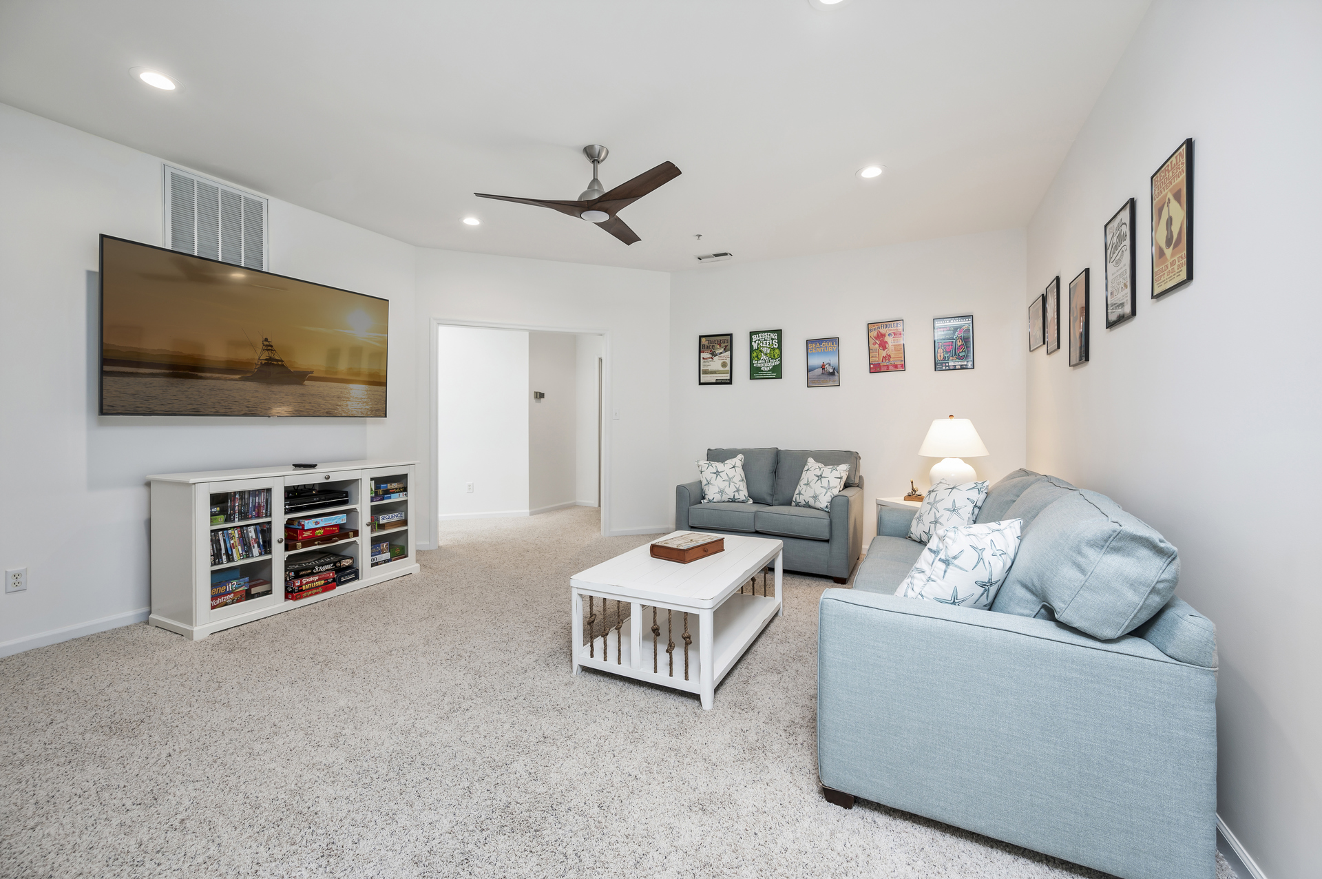 Lower level living area with couch and love seat and 75