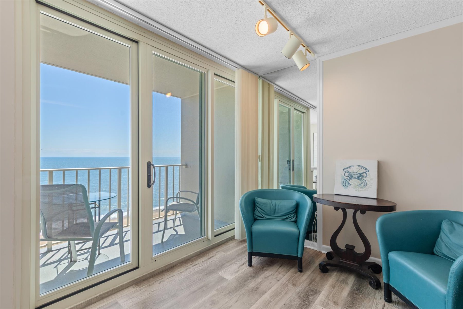 Bright sliding glass doors flood the room with natural light and lead you directly to your seaside paradise.