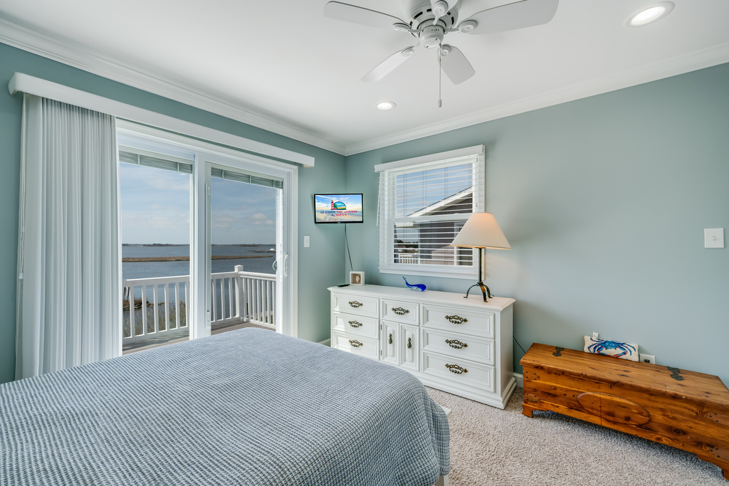 Bedroom 1 has a plush Queen bed and flat screen TV.