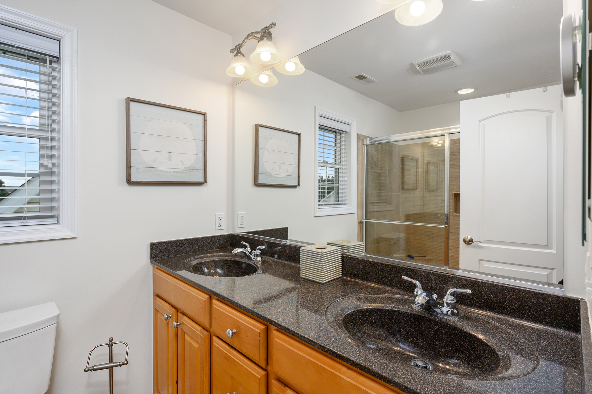 The 2nd Bath, attached to Bedroom 2 has another double vanity and a walk-in shower