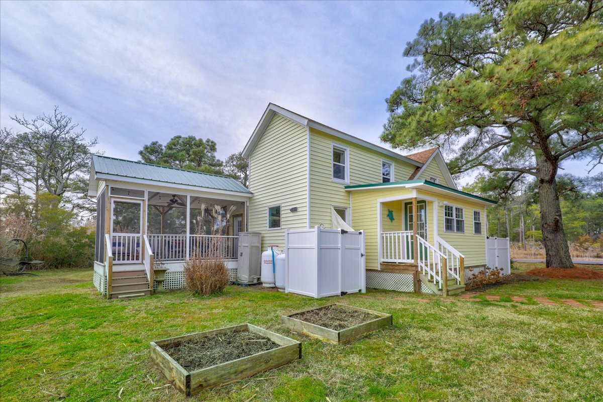 A fabulous Screened Porch overlooks the Tidal Pond on the back of Beachgrass Bungalow.